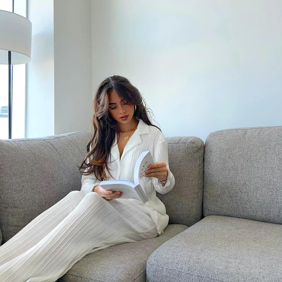 Woman reading on modern grey Favn Living sofa in bright, minimalist living room