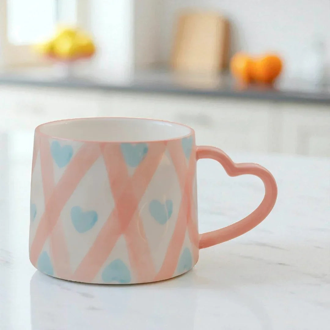 Ceramic coffee mug with pink heart-shaped handle and blue hearts, Favn Living kitchenware